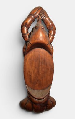 an image of a wooden sculpture of a man holding his hands on his head