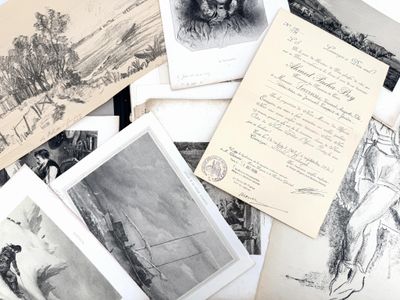 a lot of old postcards that are laying on a table