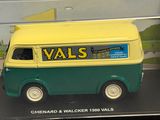 a toy van in a clear case on a table