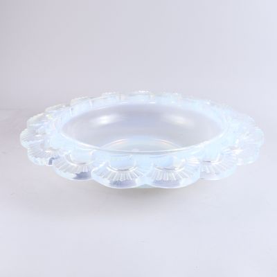 un saladier en verre transparent posé sur une surface blanche
