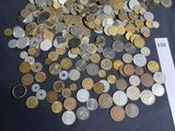 a pile of coins on a table next to a piece of paper