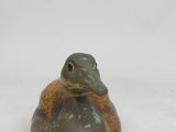 an image of a small frog figurine on a white surface