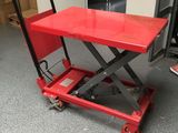 an image of a red scissor sitting in a garage