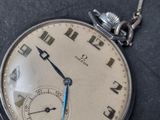 a close up of a pocket watch on a table