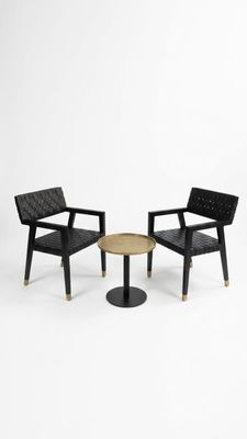 two chairs and a table in a white room with a white background