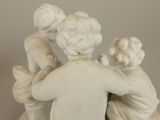 a figurine of a group of people hugging each other