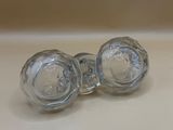 pair of clear glass knobs on a white counter top