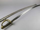 a close up of two swords on a white surface