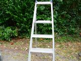a ladder that is sitting in the middle of the road