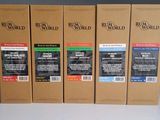 four boxes of coffee sit on a table in front of a gray wall