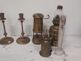 a lot of antique brass items on the table