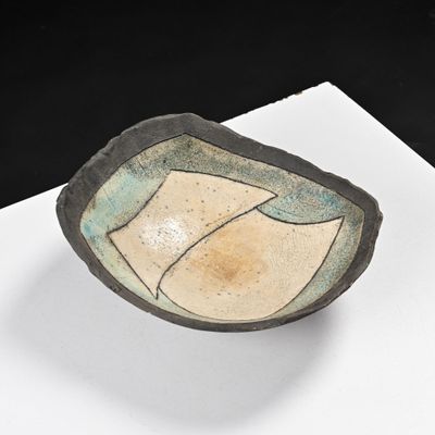 a small bowl sitting on top of a white table