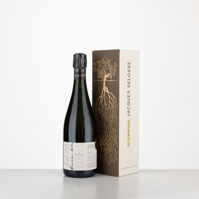 a bottle of wine next to a box on a table