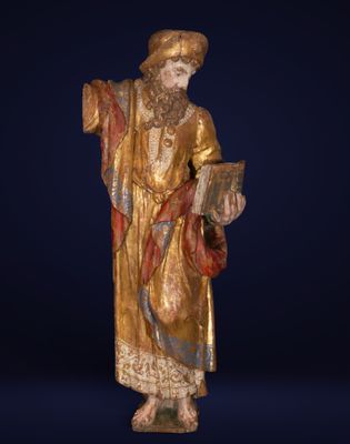 a statue of a man in a golden robe holding a book