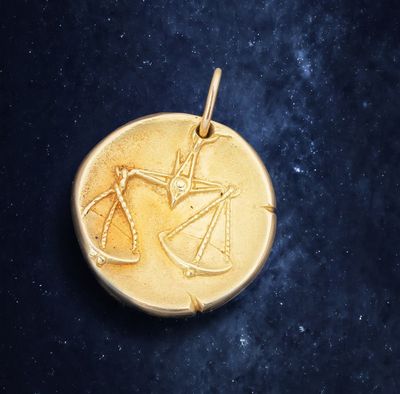 a close up of a gold coin on a black background