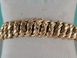 a close up of a gold bracelet on a mannequin mannequin
