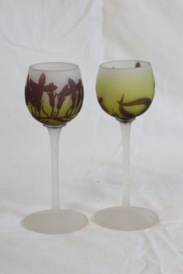 two wine glasses with horses on them on a white background
