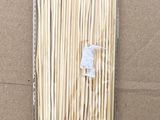 a close up of a package of bamboo sticks on a cardboard surface