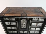 a black and white chest of drawers on a white background