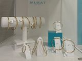a display of jewelry on display in a glass case