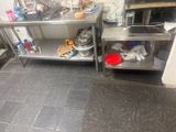 a kitchen with a lot of stainless steel counter tops