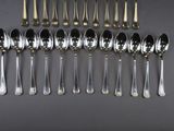 a lot of silver spoons and spoons on the table