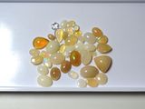 a white plate with some yellow and white stones on it