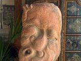a sculpture of a face on a cabinet in a room