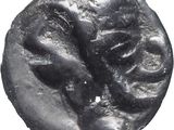 a close up of a coin with a face on it