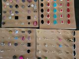 Quatre paires de boucles d'oreilles sont exposées dans une vitrine posée sur une table