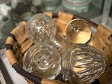a wicker basket filled with glassware on a window sill
