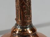 a large copper vase with a decorative design on it