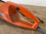 a chainsaw that is sitting on the floor