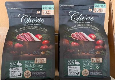 two bags of dog food sitting on top of a counter