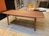 a wooden table with a laptop on it in a room