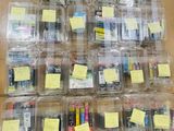 many different types of electronics in plastic containers on the table
