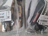 two bags of shoes that have been wrapped in plastic