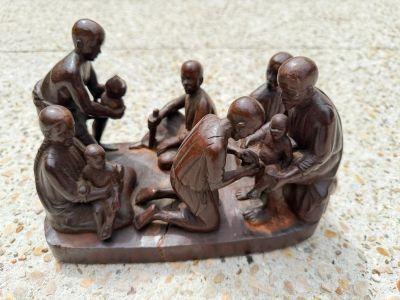 a statue of a group of people sitting on a boat