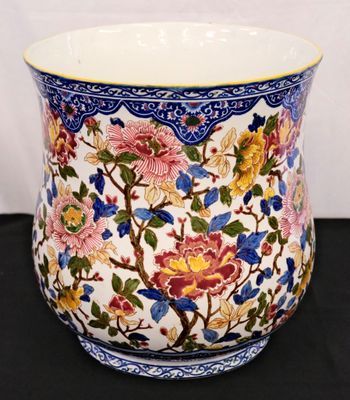 a vase with a floral design on it on a table