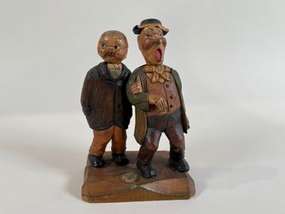 two figurines of two men standing next to each other