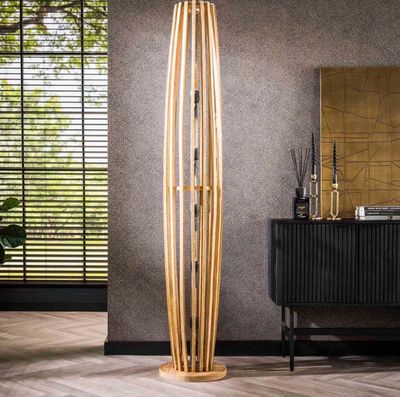 une photo d'un grand lampadaire en bois dans un salon
