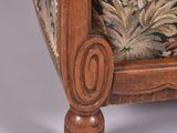 a wooden chair with a floral upholstered seat