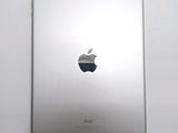 an apple ipad sitting on top of a white table next to a white wall