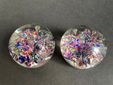 two glass marbles are sitting on top of a table