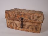 an old wooden trunk with a metal latch on it