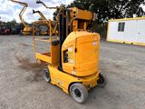 a yellow forklift sitting in the middle of a parking lot
