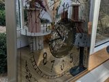 a picture of a clock that is on a window sill
