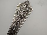 a close up of a spoon on a table with a white background