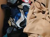 a cardboard box filled with clothes and clothing items