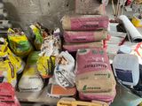 a pile of bags of cement next to a pile of bags of cement